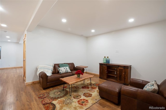 living area with wood finished floors, recessed lighting, and baseboards