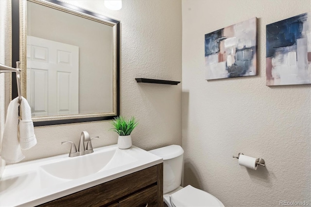 2857 Xanthia Ct, Denver, CO 80238 - bathroom featuring toilet, a textured wall, and vanity