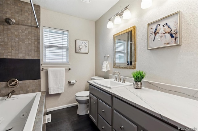 2857 Xanthia Ct, Denver, CO 80238 - bathroom featuring a jetted tub, vanity, toilet, and baseboards