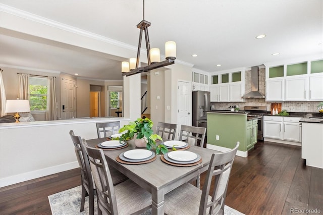 2857 Xanthia Ct, Denver, CO 80238 - dining room with a barn door, dark wood-style flooring, recessed lighting, crown molding, and baseboards