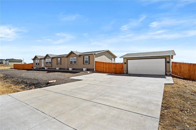 ranch-style home with a garage and fence