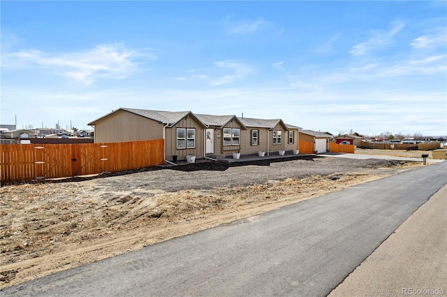 view of front of home featuring fence