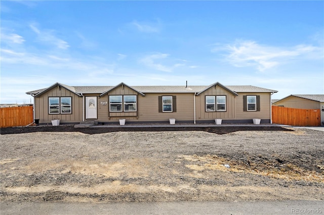 manufactured / mobile home featuring board and batten siding and fence