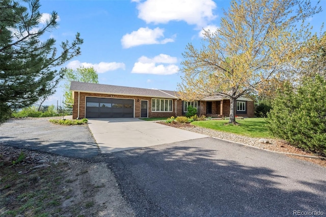 1198 Crestmoor Dr, Boulder, CO 80303 - ranch-style house featuring driveway, a garage, brick siding, and a front yard