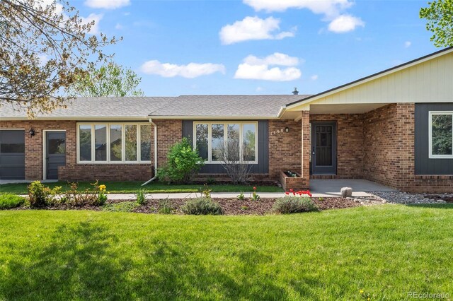 1198 Crestmoor Dr, Boulder, CO 80303 - view of front facade featuring a front yard, brick siding, and a shingled roof