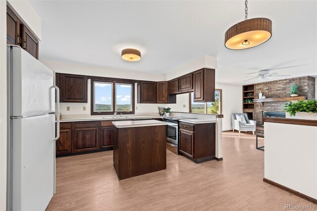 1198 Crestmoor Dr, Boulder, CO 80303 - kitchen featuring freestanding refrigerator, electric stove, dark brown cabinetry, and open floor plan