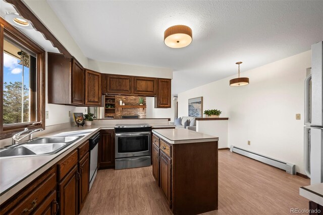 1198 Crestmoor Dr, Boulder, CO 80303 - kitchen with baseboard heating, white appliances, light wood-style floors, light countertops, and decorative light fixtures