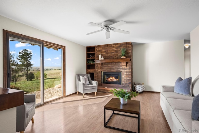 1198 Crestmoor Dr, Boulder, CO 80303 - living area featuring wood finished floors, a brick fireplace, and a ceiling fan
