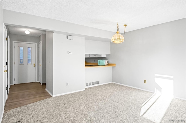 interior space with a textured ceiling