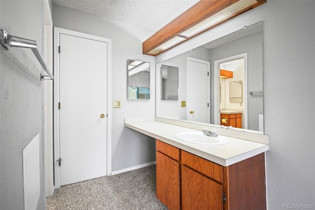 bathroom with vanity and a textured ceiling