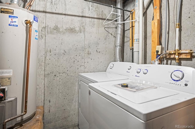 clothes washing area with water heater and washer and clothes dryer