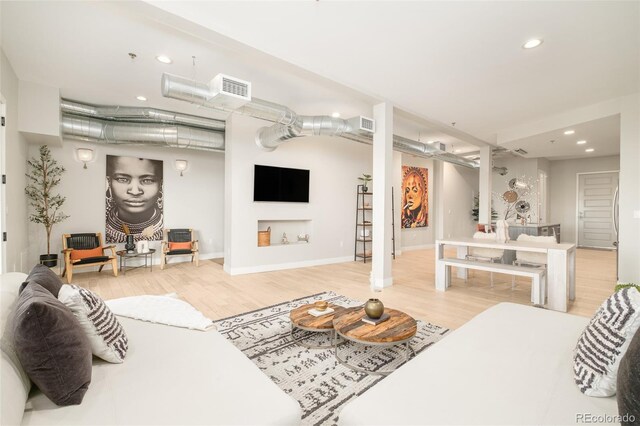 3198 Blake St Unit 402, Denver, CO 80205 - living room featuring wood finished floors and recessed lighting