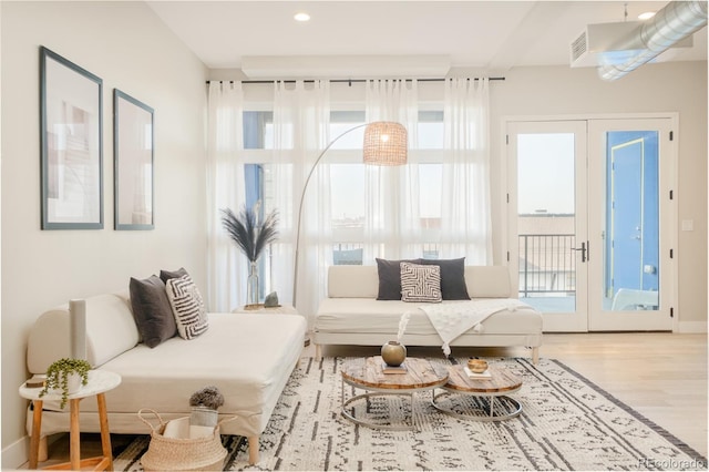3198 Blake St Unit 402, Denver, CO 80205 - living area with french doors, wood finished floors, and recessed lighting