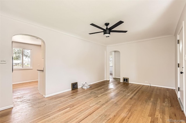 4111 S Delaware St, Englewood, CO 80110 - empty room featuring arched walkways, ceiling fan, and wood finished floors