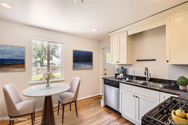 4111 S Delaware St, Englewood, CO 80110 - kitchen with stainless steel dishwasher, dark countertops, recessed lighting, light wood-type flooring, and range with gas cooktop