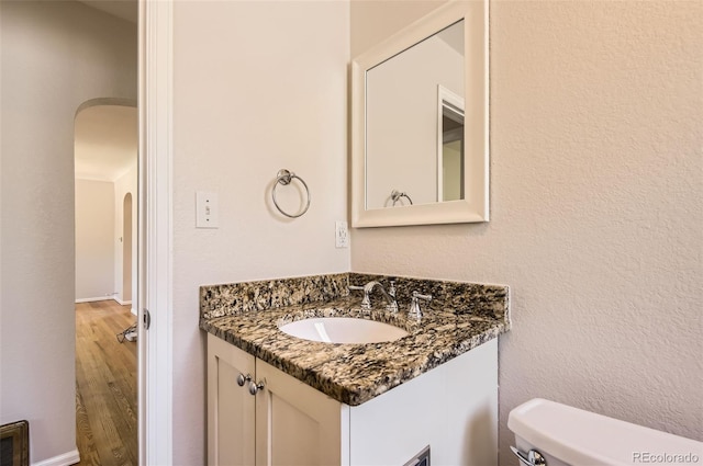 4111 S Delaware St, Englewood, CO 80110 - half bath featuring vanity and wood finished floors