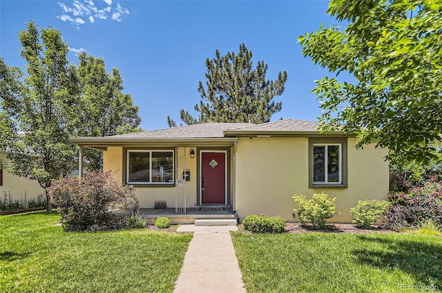 4111 S Delaware St, Englewood, CO 80110 - view of front of home with stucco siding, a front yard, and roof with shingles