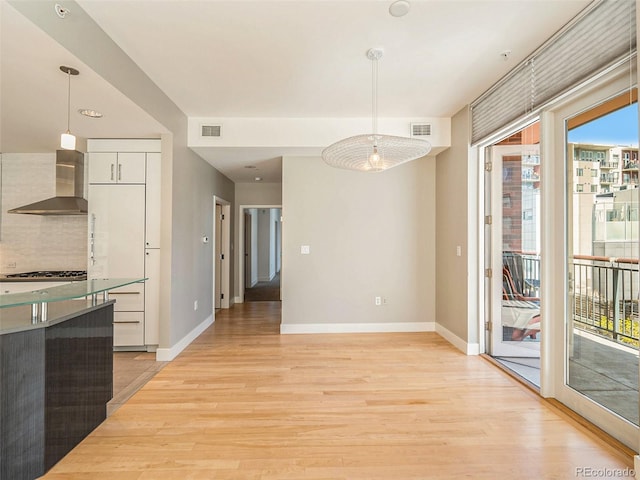 unfurnished dining area with light hardwood / wood-style floors