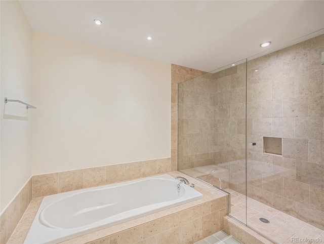 bathroom with tile patterned floors and independent shower and bath