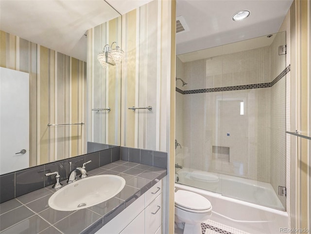 full bathroom with tile patterned flooring, vanity, toilet, and tiled shower / bath