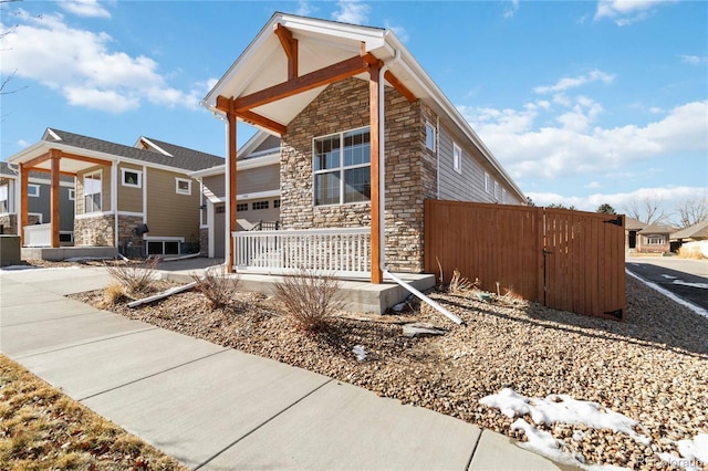 view of property exterior with a garage and covered porch