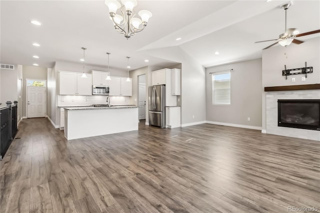 kitchen with white cabinetry, stainless steel appliances, an island with sink, and hanging light fixtures