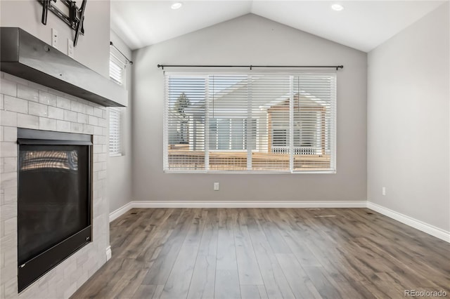 unfurnished living room featuring lofted ceiling and dark wood-type flooring