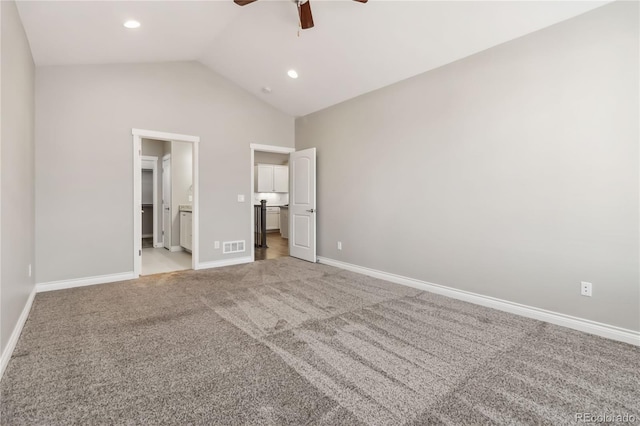 unfurnished bedroom with ensuite bathroom, lofted ceiling, carpet, and ceiling fan