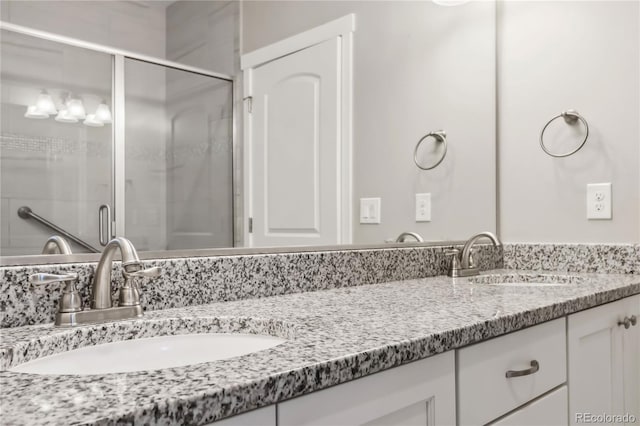 bathroom with vanity and an enclosed shower