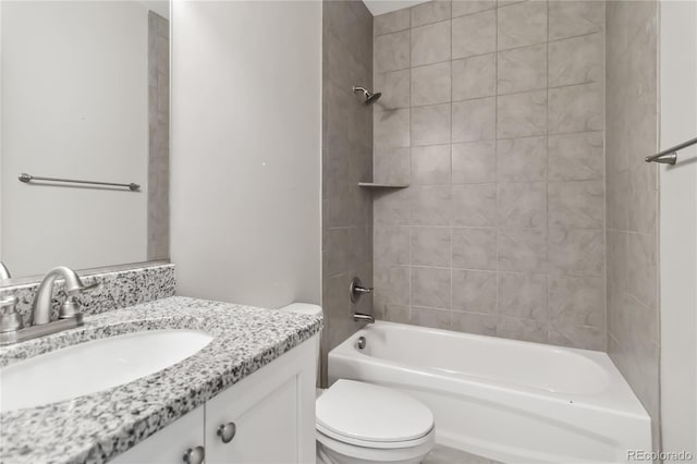 full bathroom with tiled shower / bath, vanity, and toilet