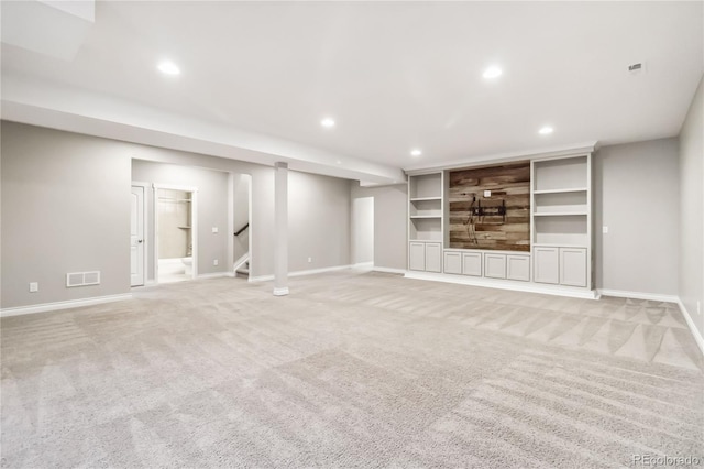 unfurnished living room featuring light carpet