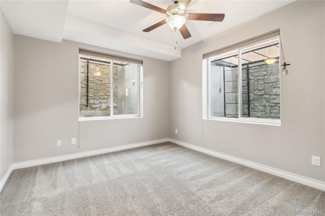 spare room featuring ceiling fan and carpet floors