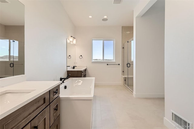 668 Leafy Aster Ln, Castle Rock, CO 80104 - full bathroom featuring a stall shower, two vanities, a soaking tub, recessed lighting, and baseboards