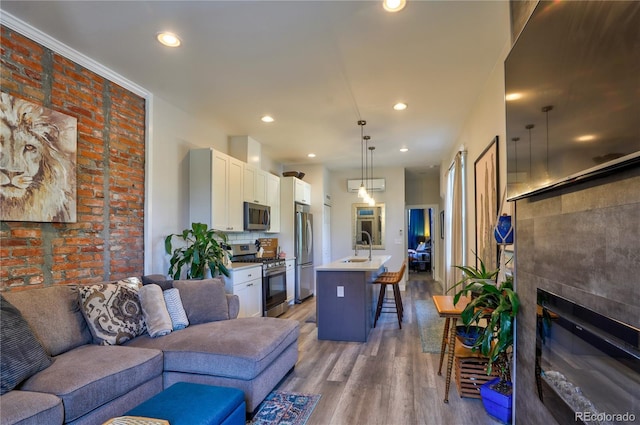 1739 E Martin Luther King Jr Blvd, Denver, CO 80205 - living room featuring light wood-style flooring, a glass covered fireplace, and recessed lighting