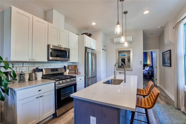1739 E Martin Luther King Jr Blvd, Denver, CO 80205 - kitchen with stainless steel appliances, light wood-style floors, light countertops, a kitchen bar, and backsplash