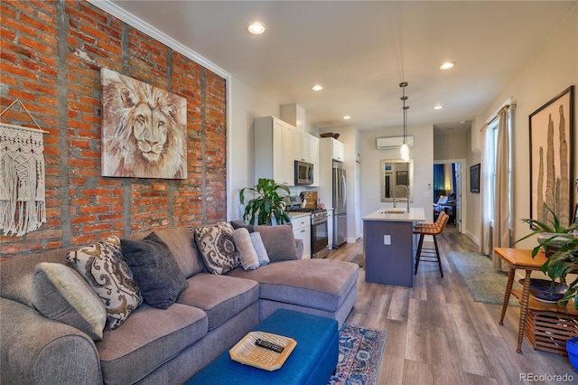 1739 E Martin Luther King Jr Blvd, Denver, CO 80205 - living area featuring light wood finished floors, recessed lighting, and brick wall