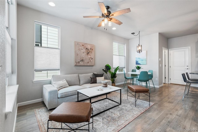 living room with light wood-type flooring and ceiling fan