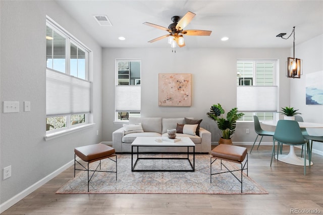 living room with ceiling fan, hardwood / wood-style floors, and a healthy amount of sunlight