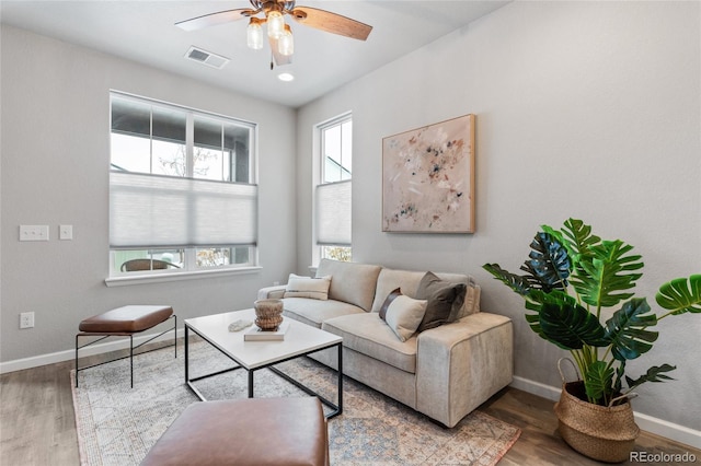 living room with wood-type flooring and ceiling fan