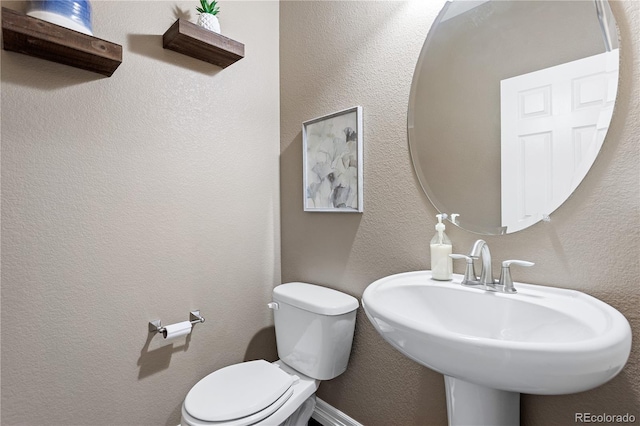 bathroom featuring sink and toilet