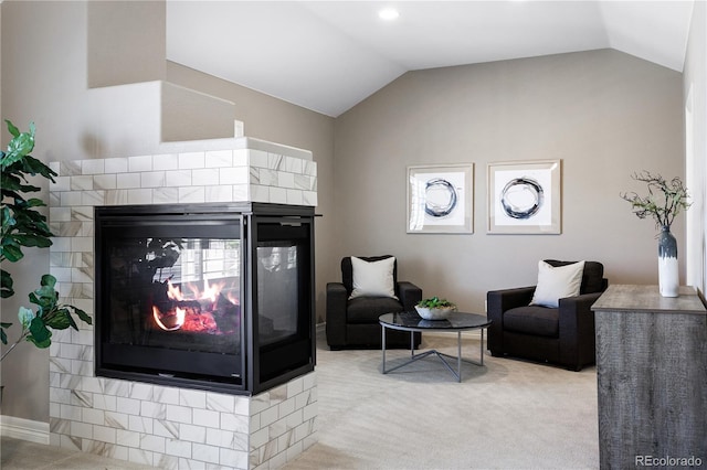 living room featuring light colored carpet, vaulted ceiling, and a multi sided fireplace