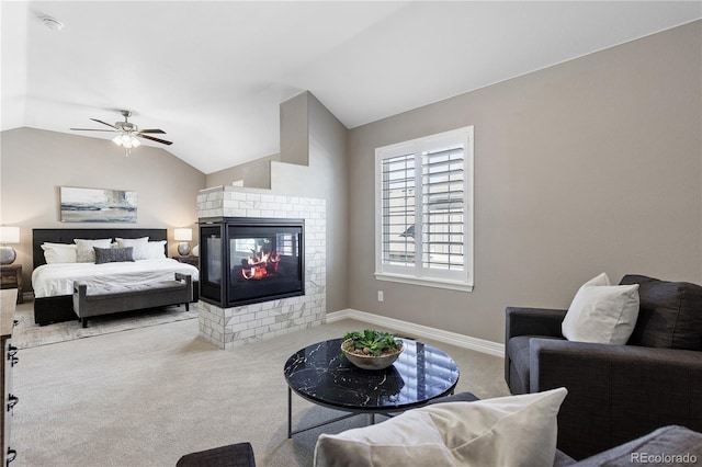 bedroom with ceiling fan, lofted ceiling, light colored carpet, and a multi sided fireplace