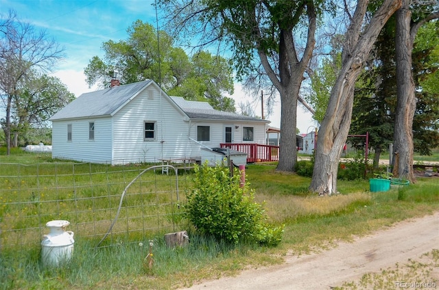 21064 Kelly St, Matheson, CO 80830 - view of front of house with a deck, roof with shingles, and a chimney