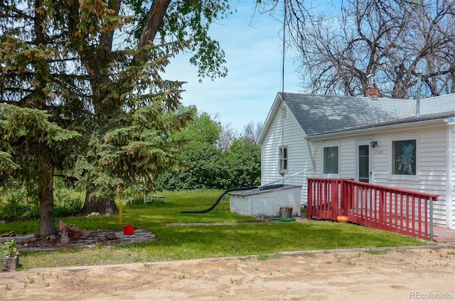 21064 Kelly St, Matheson, CO 80830 - view of property exterior featuring a chimney, a lawn, and roof with shingles