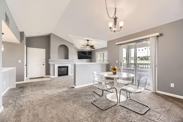 12824 Ironstone Way Unit 303, Parker, CO 80134 - dining room with a ceiling fan, carpet, a chandelier, lofted ceiling, and a glass covered fireplace