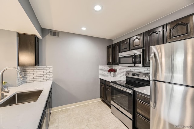 12824 Ironstone Way Unit 303, Parker, CO 80134 - kitchen with stainless steel appliances, light countertops, decorative backsplash, and recessed lighting
