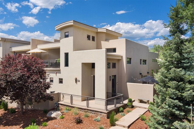 114 El Paso Blvd, Manitou Springs, CO 80829 - view of front of property with stucco siding and a balcony