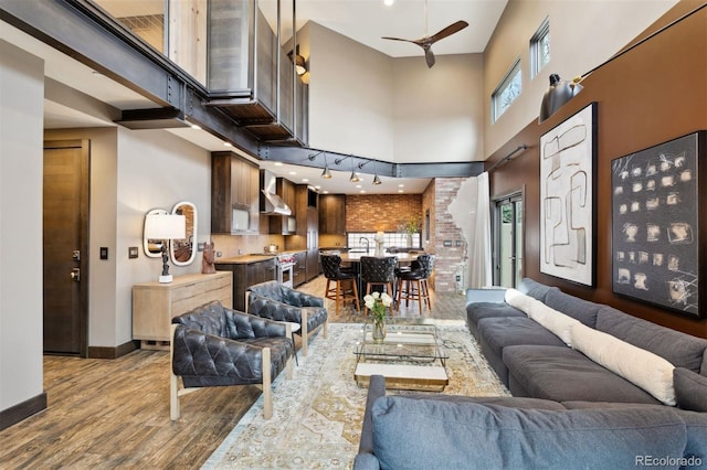114 El Paso Blvd, Manitou Springs, CO 80829 - living area featuring a towering ceiling, wood finished floors, and a ceiling fan