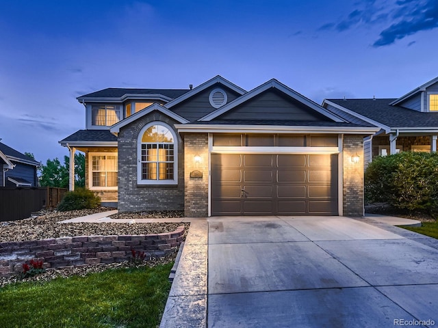 9412 Burgundy Cir, Highlands Ranch, CO 80126 - view of front of home featuring brick siding, driveway, an attached garage, and a shingled roof