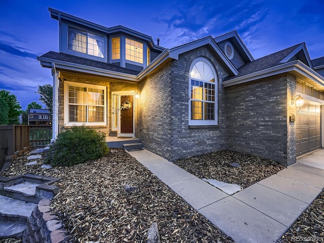 9412 Burgundy Cir, Highlands Ranch, CO 80126 - view of front of home featuring brick siding, a garage, and a shingled roof